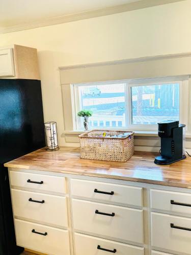a kitchen with a counter top with a window at Charming Modernized Farmhouse in Moxee City