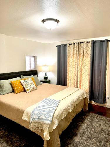 a bedroom with a large bed with curtains at Charming Modernized Farmhouse in Moxee City