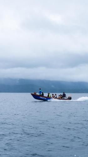 a group of people in a boat on the water at PRIMITIVO LODGE & dive center in Bahía Solano