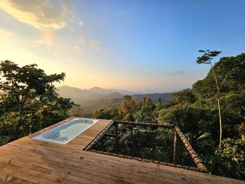 a jacuzzi tub on top of a building with a mountain at BAJO EL CIELO Glamping MINCA in Minca