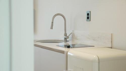 a kitchen with a sink and a refrigerator at Stay Yongdam in Jeju