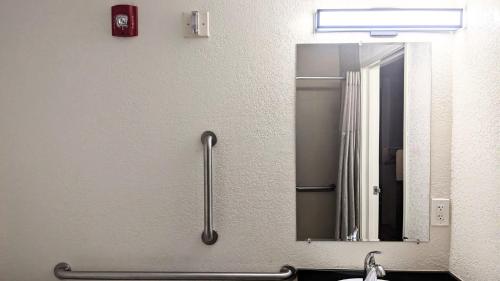 a bathroom with a mirror and a sink at Motel 6 Ogden, UT- Downtown in Ogden