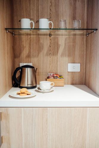 a counter with a tea kettle and plates on it at Mary MacKillop Place in Sydney