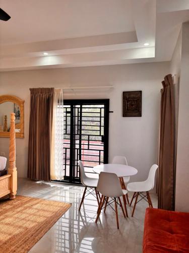 a living room with a white table and chairs at Beachscape At Black River Ethlyn by the sea in Black River