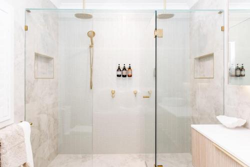 a shower with a glass door in a bathroom at The Lookout in Bargara
