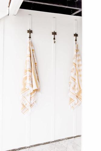 a row of white cabinets with towels hanging from them at The Lookout in Bargara
