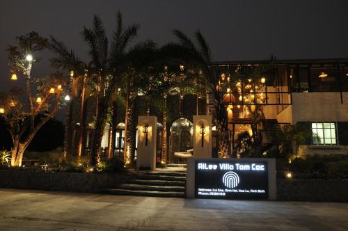 a sign in front of a building at night at Ailee Villa&Hotel TamCoc in Ninh Binh