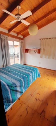 a bedroom with a bed and a ceiling fan at La Reserva in Los Altos