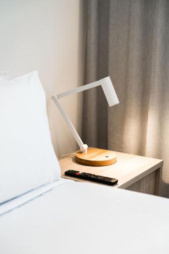 a lamp sitting on a table next to a bed at Mary MacKillop Place in Sydney