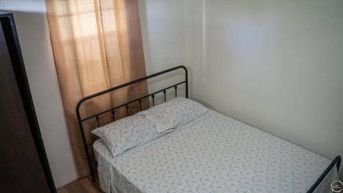 a small bed with a pillow on it in a room at Beautiful Modern Caribbean Oasis in Salisbury