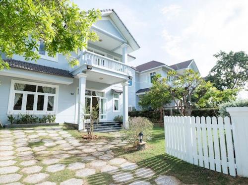 a white fence in front of a white house at Villa Sea Links ( Biệt Thự nghỉ dưỡng ) in Ấp Phú Tịnh (2)