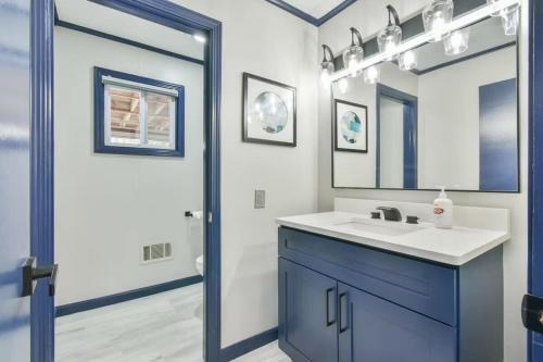 a bathroom with a sink and a mirror at Lake Lanier, Lakefront, Boating, Hot Tube, Games, Luxury, Family, Friends, Hiking, Fishing and Birdwatching in Flowery Branch