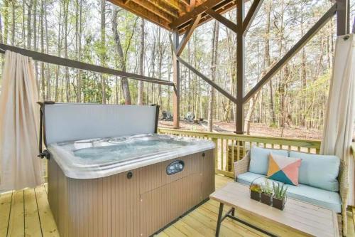 a hot tub on a deck with a bench at Lake Lanier, Lakefront, Boating, Hot Tube, Games, Luxury, Family, Friends, Hiking, Fishing and Birdwatching in Flowery Branch