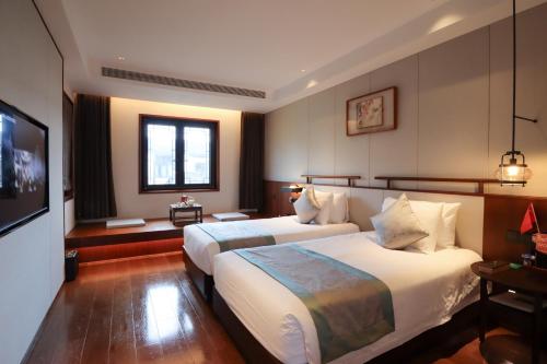 Yuyao Yangmingguan Hotelにあるベッド