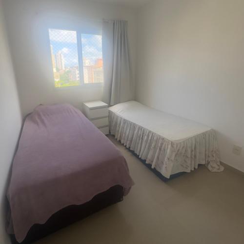 Letto o letti in una camera di Cond Twice Guaruja Sp