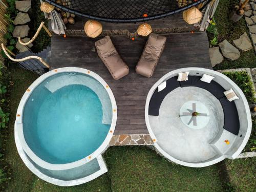 an overhead view of a swimming pool with boots next to it at Nivriti Bali in Sidemen