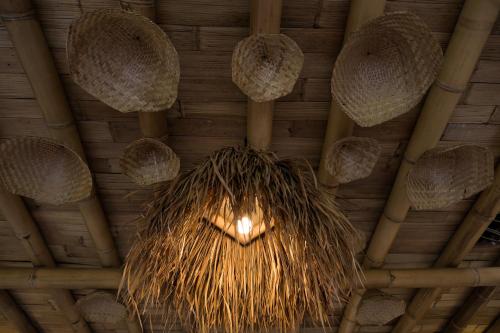 a chandelier hanging from the ceiling of a building at Nivriti Bali in Sidemen