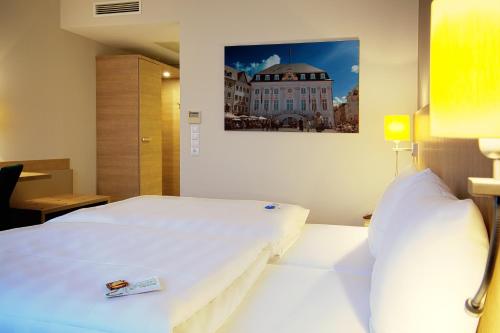 Ένα ή περισσότερα κρεβάτια σε δωμάτιο στο Best Western Hotel President