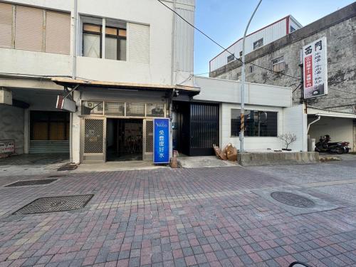 an empty street in a city with a building at 16 Post Station Single Tour in Hengchun