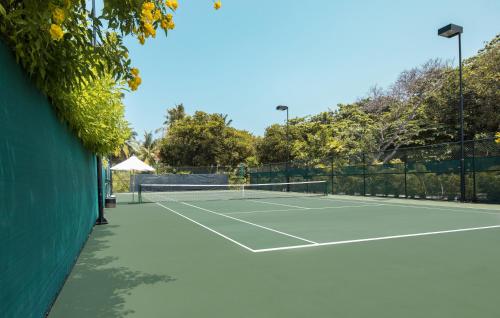 a tennis court with a tennis ball on it at Sirru Fen Fushi Private Lagoon Resort Maldives in Shaviyani Atoll