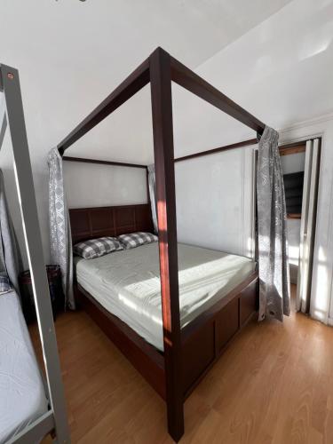 a bedroom with a canopy bed in a room at Quesada Homestay in San Francisco