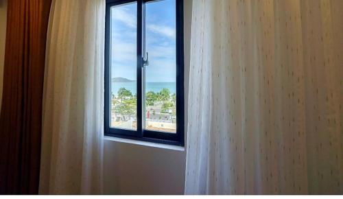 a window with a view of the ocean at Mira Eco Hotel Quy Nhon in Quy Nhon