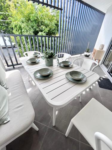 a white table and chairs on a balcony at Location, location, location - very large apartment in Brisbane