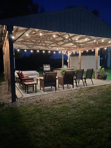 a group of benches under a pergola with lights at Scippo Creek Farm in Circleville