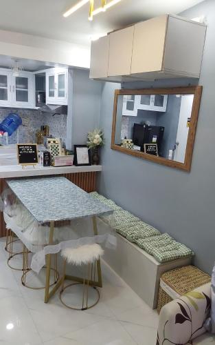 a kitchen with a counter and a table with stools at The Little Nest Guest House in Bantug