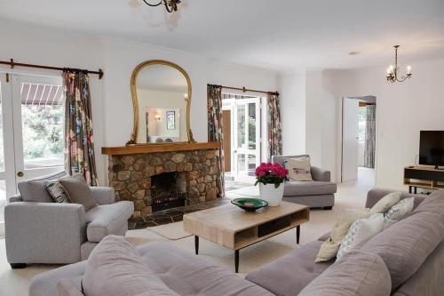 a living room with a couch and a fireplace at Mountain Bike Manor in Rotorua