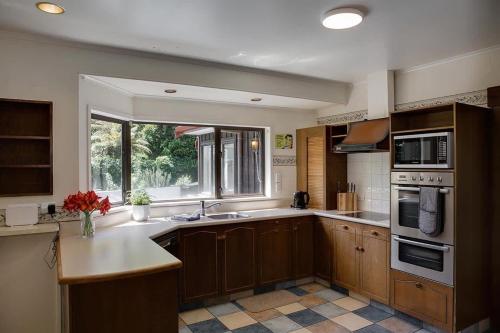 a large kitchen with a sink and a window at Mountain Bike Manor in Rotorua
