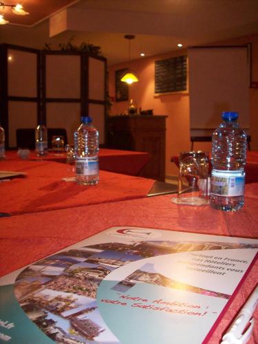 two bottles of water sitting on top of a table at Kimotel Epône-Flins in Épône