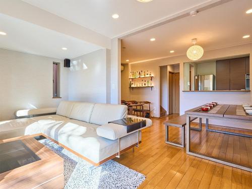 a living room with a white couch and a table at KandoStay TOKYOテラス in Tokyo