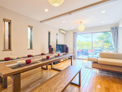 a living room with a table and a couch at KandoStay TOKYOテラス in Tokyo
