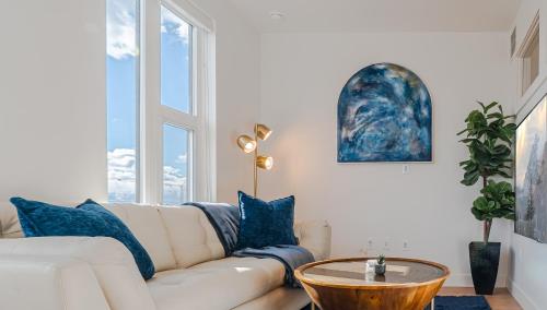 a living room with a white couch and a table at Top floor Deluxe 1BR Pool,Gym,Htub,Bowling and More in Salt Lake City