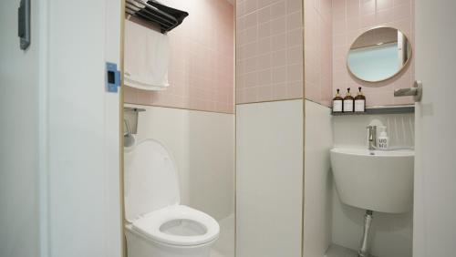 a small bathroom with a toilet and a sink at Stay Yongdam in Jeju
