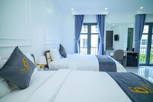 a hotel room with two beds and a balcony at 6668 Hotel - Chi nhánh 1 in Tây Ninh
