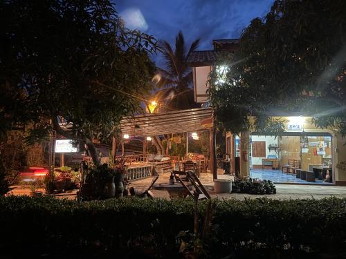 a building with a patio at night at Baan Klong House in Baan Khai