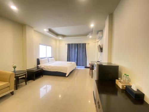 a hotel room with a bed and a couch at Buddy hotel in Pattaya