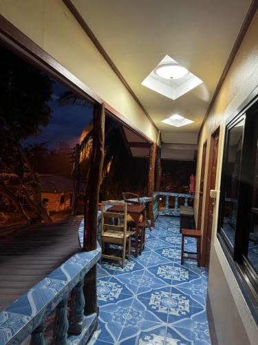 a porch with a table and chairs on a deck at Baan Klong House in Baan Khai