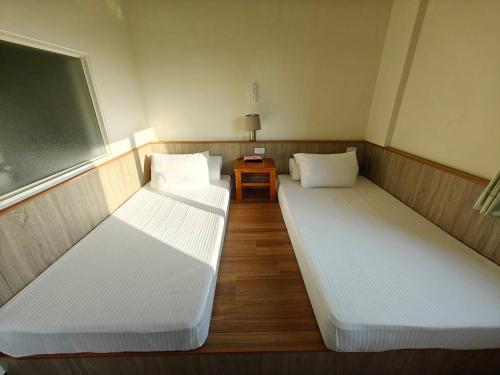 Postel nebo postele na pokoji v ubytování Li Yuan Homestay