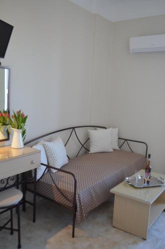 a living room with a bed and a table at Archontissa in Ermoupoli