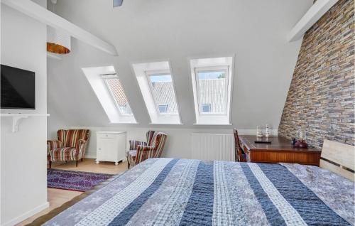 a bedroom with a bed and a brick wall at 3 Bedroom Gorgeous Home In Assens in Assens