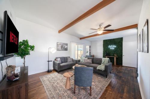 a living room with a couch and a tv at Charming,comfy home near San Antonio's top sights in San Antonio