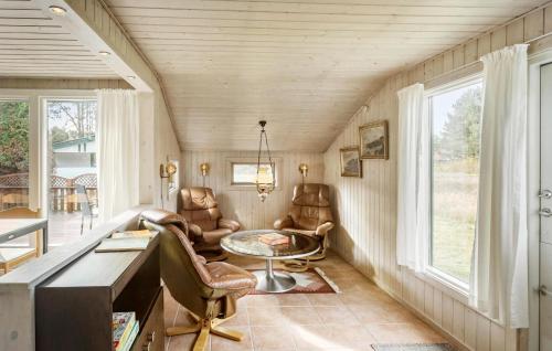 a home office with leather chairs and a table and windows at 3 Bedroom Stunning Home In Rødby in Rødby