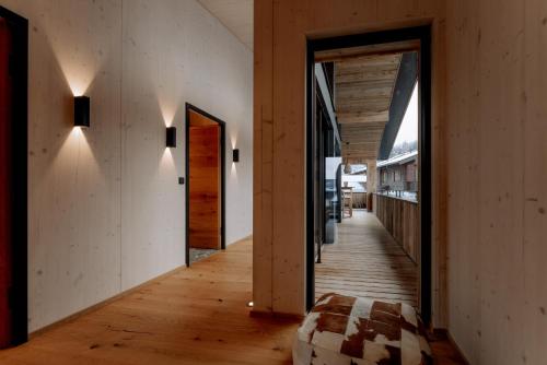 a hallway of a house with wooden floors and wooden ceilings at Alpenlodges in Schönau am Königssee