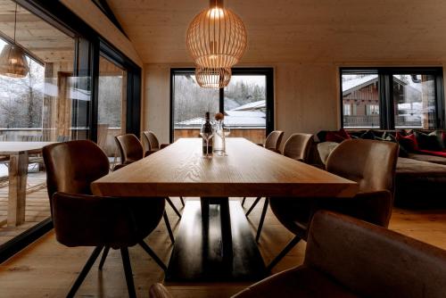 a dining room with a wooden table and chairs at Alpenlodges in Schönau am Königssee