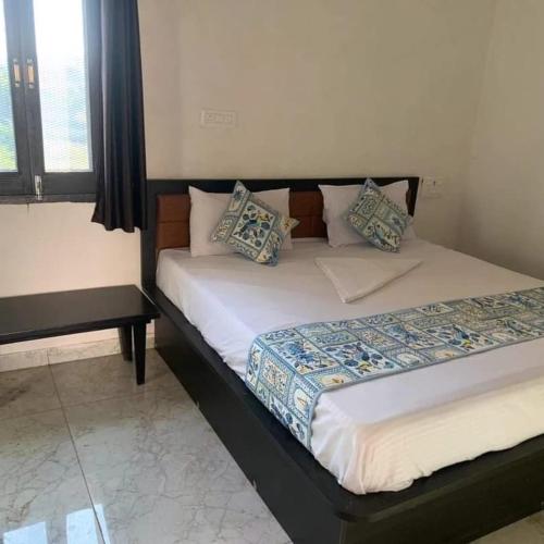 a bed with pillows on it in a room at Panwar holidays homes in Chirwa