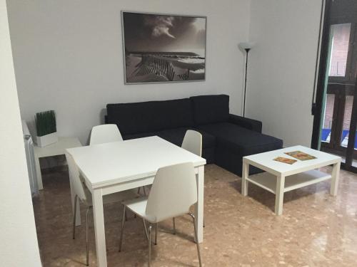 a living room with a couch and a table and chairs at Apartamento Torre del Salvador in Teruel