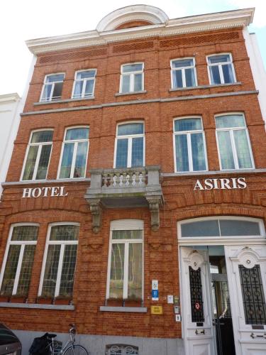 a red brick building with a hotel in front of it at Hotel Asiris in Bruges